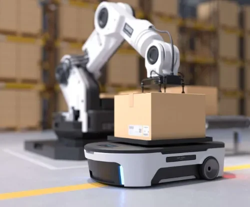 Robot arm loading a box onto an autonomous mobile robot